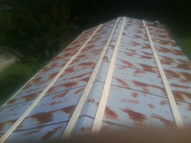 Rusted metal roof panels with new wood purlins before replacement — Storm Damage Roof Repair in Beacon Falls by Roofing Brothers