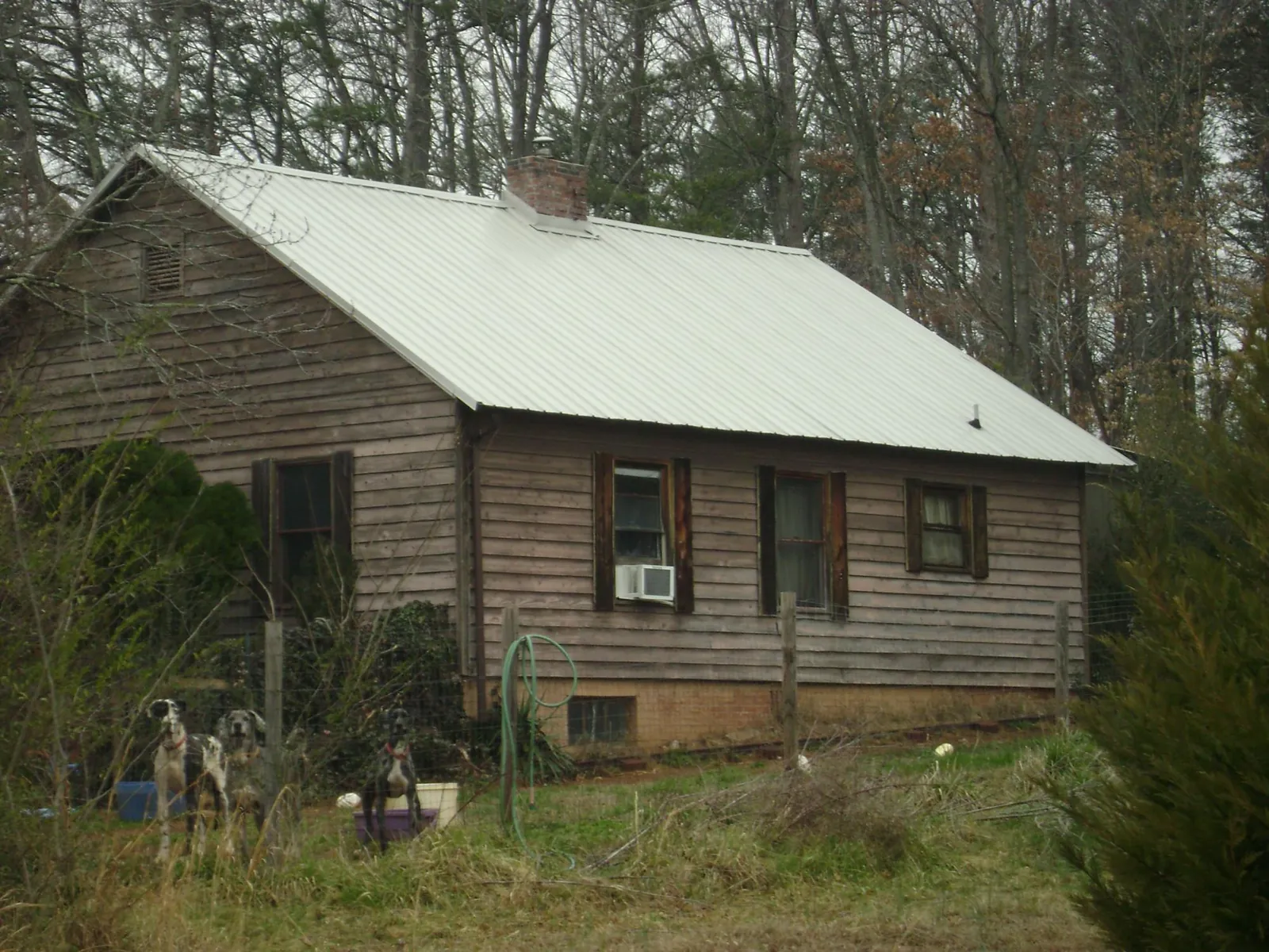 White metal roof on an old wood sided farmhouse, from a Metal Roof Installation job in Beacon Falls